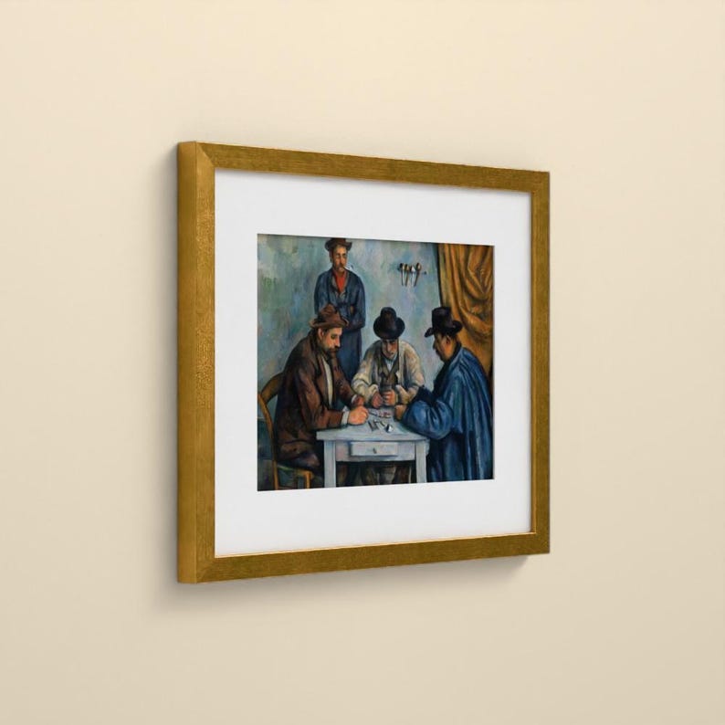 May include: A framed art print depicting a painting of four individuals gathered around a small table. Three people are seated playing cards, while one person stands behind them. The scene features muted blue, brown, and gold tones.