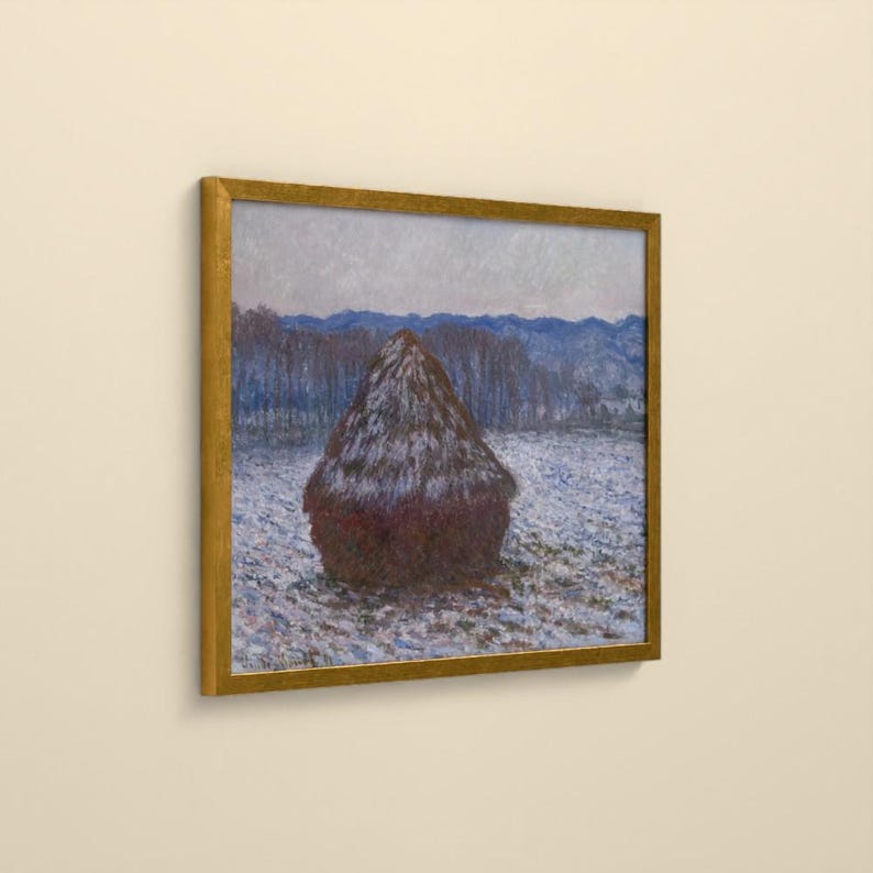 May include: A framed painting depicting a dark brown haystack centered in a snowy field under a pale sky. The landscape features blue-toned trees and distant hills in the background, all enclosed within a simple, thin gold-colored frame.