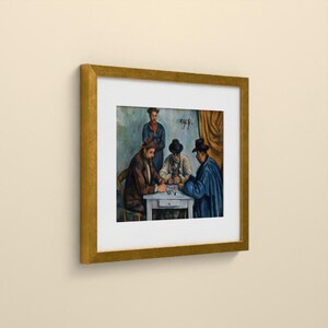 May include: A framed art print featuring a painting of four individuals gathered around a small white table. Three people are seated, wearing hats and dark coats, while one person stands behind them. The scene is rendered in muted tones.