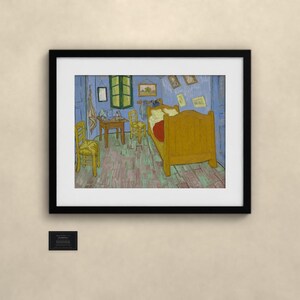 May include: A framed art print depicting a bedroom scene with a yellow bed, two yellow chairs, a wooden table, and blue walls. The painting features a green window, several small framed pictures on the wall, and a red blanket on the bed.