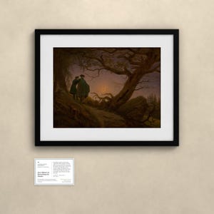 May include: A framed art print featuring a dark landscape with two figures standing on a hill under a crescent moon and gnarled trees. Below the frame is a small white informational card with the text Two Men Contemplating the Moon.