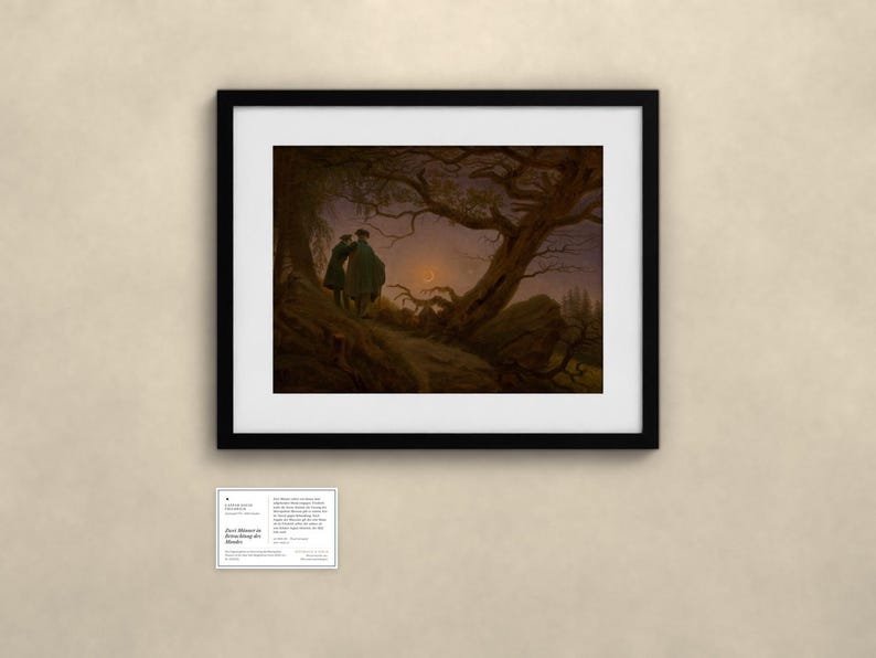 May include: A framed art print featuring a dark landscape with two figures standing on a hill under a crescent moon and gnarled trees. Below the frame is a small white informational card with the text Two Men Contemplating the Moon.