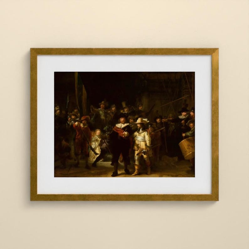 May include: A framed art print of Rembrandt's The Night Watch, featuring a group of figures in dark, dramatic clothing with highlights of red, yellow, and white. The painting is encased in a gold-toned frame with a white mat border.