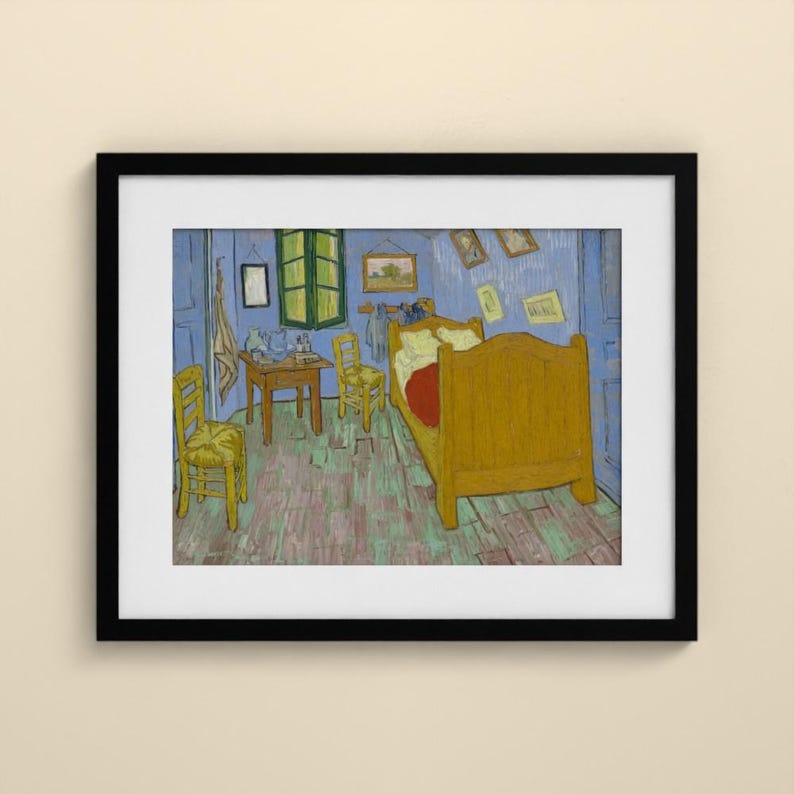 May include: A framed print of a painting depicting a bedroom with blue walls and a wooden floor. The room contains a large yellow bed, two yellow chairs, a small wooden table, and several framed pictures hanging on the walls near a green window.