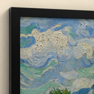May include: A framed oil painting print featuring thick, textured brushstrokes in shades of light blue, white, and pale green. The artwork displays swirling, cloud-like patterns across the canvas, enclosed within a simple black frame.