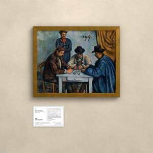 May include: An oil painting in a gold frame depicting four individuals seated around a white table playing cards. Three figures wear hats and dark coats, while one stands behind them. A small white informational plaque is mounted below the artwork.