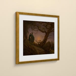 May include: A framed art print featuring a dark, atmospheric landscape painting of two figures standing under a large, gnarled tree at twilight. A thin crescent moon is visible in the sky. The artwork is enclosed in a square gold frame with a white mat.