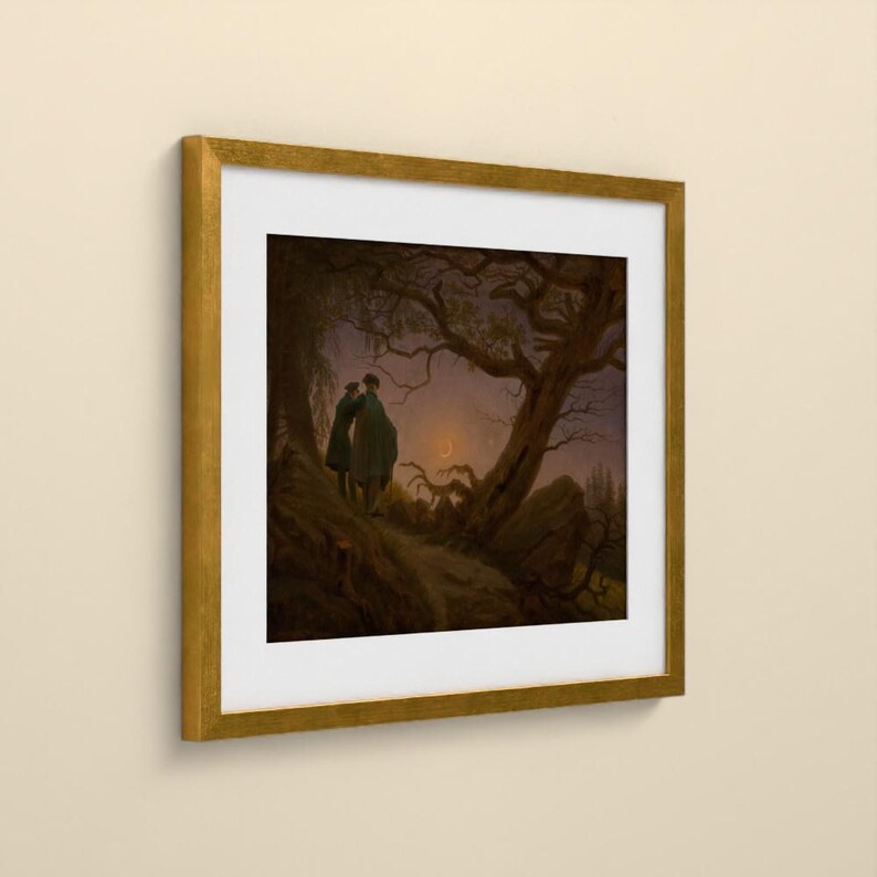 May include: A framed art print featuring a dark, atmospheric landscape painting of two figures standing under a large, gnarled tree at twilight. A thin crescent moon is visible in the sky. The artwork is enclosed in a square gold frame with a white mat.
