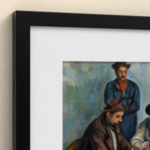 May include: A framed art print featuring a painting of two men wearing hats. One man in the foreground wears a brown jacket, while the man behind him wears a blue jacket and a red scarf, with a pipe in his mouth. The artwork is enclosed in a black frame.