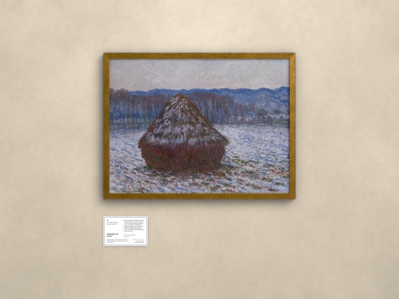 May include: A framed landscape painting featuring a large, dark brown haystack centered in a snowy field. The background displays blue-toned trees and distant mountains under a pale sky. A small white informational placard is positioned below the frame.