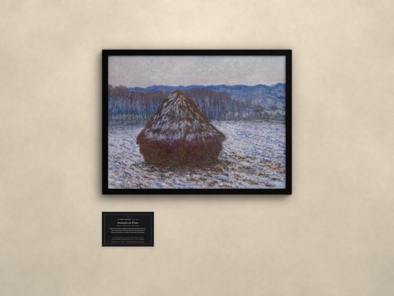 May include: A framed print of Claude Monet's Haystacks in Winter, featuring a dark brown haystack in a snow-covered field with blue-toned trees and mountains in the background. A small black informational plaque is mounted below the framed artwork.