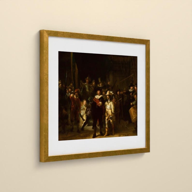 May include: A framed art print of Rembrandt's The Night Watch, featuring a group of figures in dark, dramatic clothing and armor. The painting is encased in a gold-toned frame with a white mat, displayed against a plain, light-colored wall.
