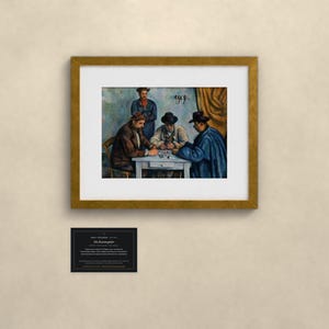 May include: A framed art print of Paul C&eacute;zanne's The Card Players, depicting three men seated at a table playing cards, with a fourth man standing behind them. The artwork is presented in a gold frame with a white mat and includes a small black informational plaque.