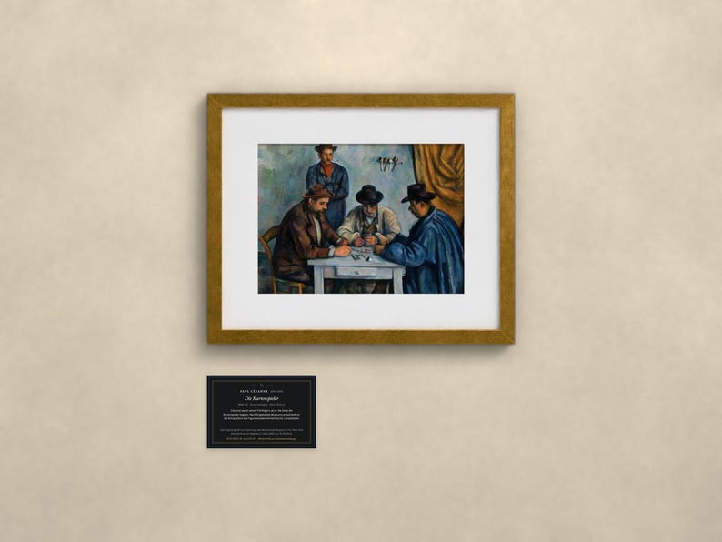 May include: A framed art print of Paul C&eacute;zanne's The Card Players, depicting three men seated at a table playing cards, with a fourth man standing behind them. The artwork is presented in a gold frame with a white mat and includes a small black informational plaque.