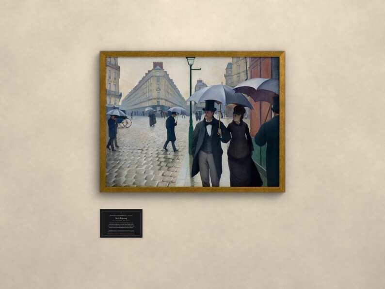 May include: A framed oil painting depicting a rainy Paris street scene with cobblestones, featuring figures in formal 19th-century attire holding umbrellas. A couple walks in the foreground under a large umbrella, with buildings and a street lamp visible.