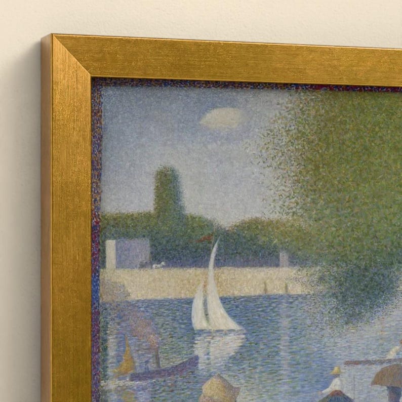 May include: A framed pointillist painting depicting a river scene with a white sailboat, green trees, and figures along the bank. The artwork is enclosed in a textured gold-colored frame with a visible inner edge and a light-colored wall background.