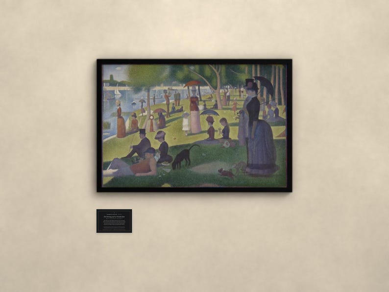 May include: A framed print of Georges Seurat's A Sunday Afternoon on the Island of La Grande Jatte, featuring a park scene with figures, umbrellas, and a dog. A small black informational plaque is mounted on the wall below the framed artwork.