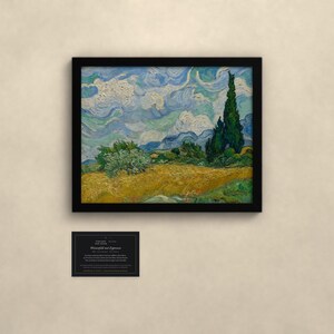 May include: A framed print of Vincent van Gogh's Wheat Field with Cypresses, featuring a golden wheat field, dark green cypress trees, and a swirling blue sky. Below the frame is a small black informational card with white text.