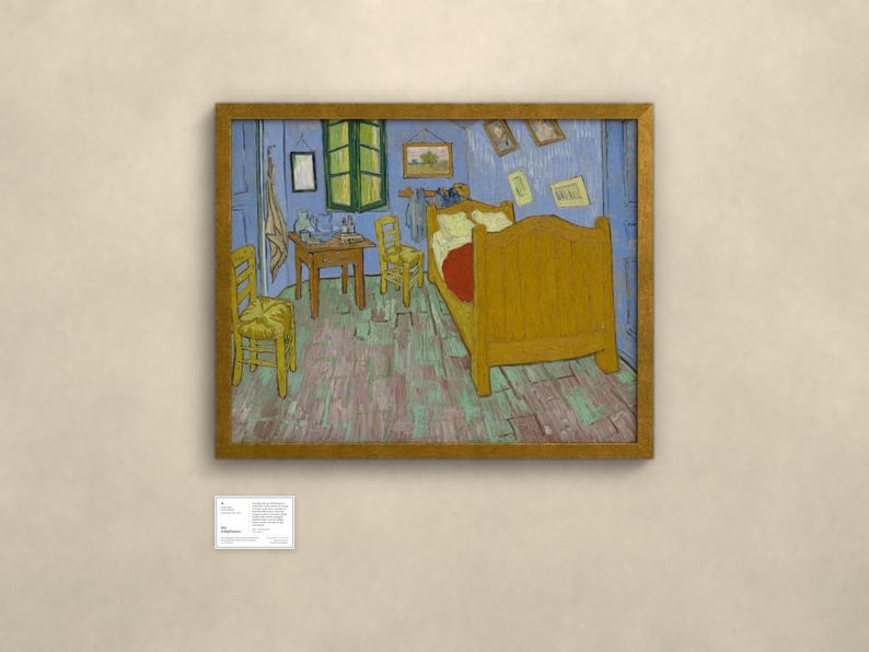 May include: A framed print of Vincent van Gogh's Bedroom in Arles painting, featuring a yellow bed, two wooden chairs, a small table, and blue walls. The artwork is displayed in a gold frame with a small white informational plaque below it.