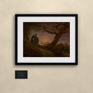 May include: A framed art print titled Two Men Contemplating the Moon, featuring a dark landscape with two figures standing on a rocky path under a large, gnarled tree, looking toward a crescent moon in a twilight sky.