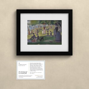 May include: A framed print of Georges Seurat's painting A Sunday on La Grande Jatte, featuring people in a park by the water, accompanied by a white informational card with black text detailing the artwork and artist.