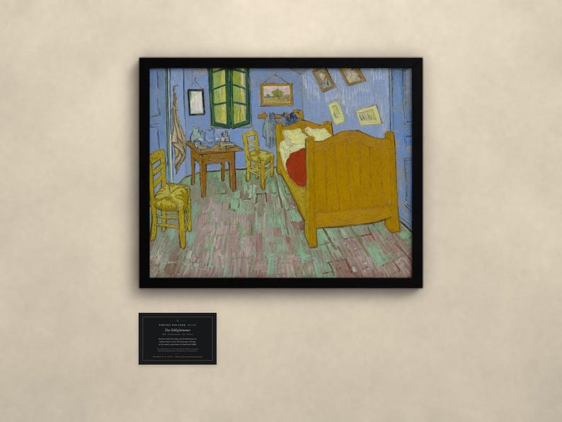May include: A framed print of Vincent van Gogh's Bedroom in Arles painting, featuring a yellow bed, two chairs, and a small table in a blue room. Below the frame is a small black plaque with white text detailing the artwork's history.