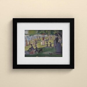 May include: A framed art print featuring a pointillist scene of people relaxing in a park by a river. The composition includes figures with parasols, a dog, and trees under a bright sky, all enclosed within a simple black frame and white mat.