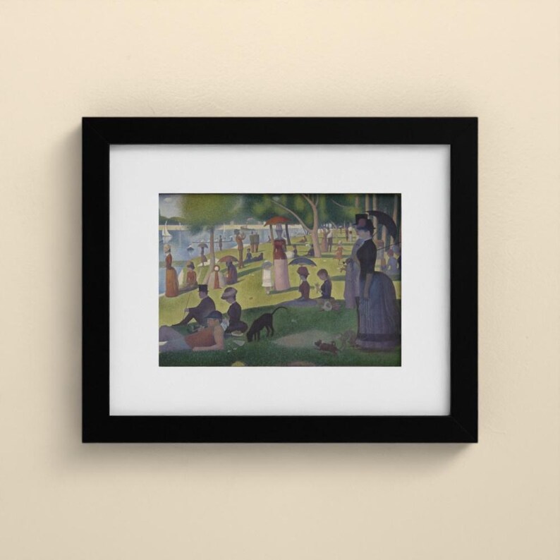 May include: A framed art print featuring a pointillist scene of people relaxing in a park by a river. The composition includes figures with parasols, a dog, and trees under a bright sky, all enclosed within a simple black frame and white mat.
