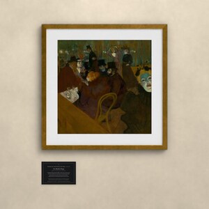May include: A framed art print featuring a dark, moody painting of a crowded cafe scene with figures in hats and a prominent pale-faced individual in the foreground. Below the frame is a small black plaque with white text detailing the artwork.