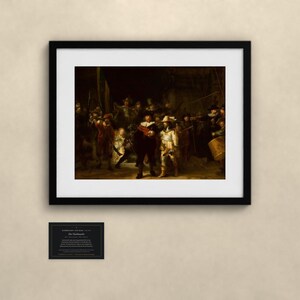 May include: A framed print of Rembrandt's The Night Watch featuring a group of figures in dark clothing with gold accents. Below the frame is a small black plaque with white text that reads Rembrandt van Rijn, The Night Watch.