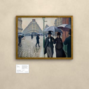 May include: A framed oil painting depicting a rainy Paris street scene with cobblestones. Several figures walk under dark umbrellas, including a couple in the foreground wearing formal attire and top hats. A tall green lamppost stands nearby.