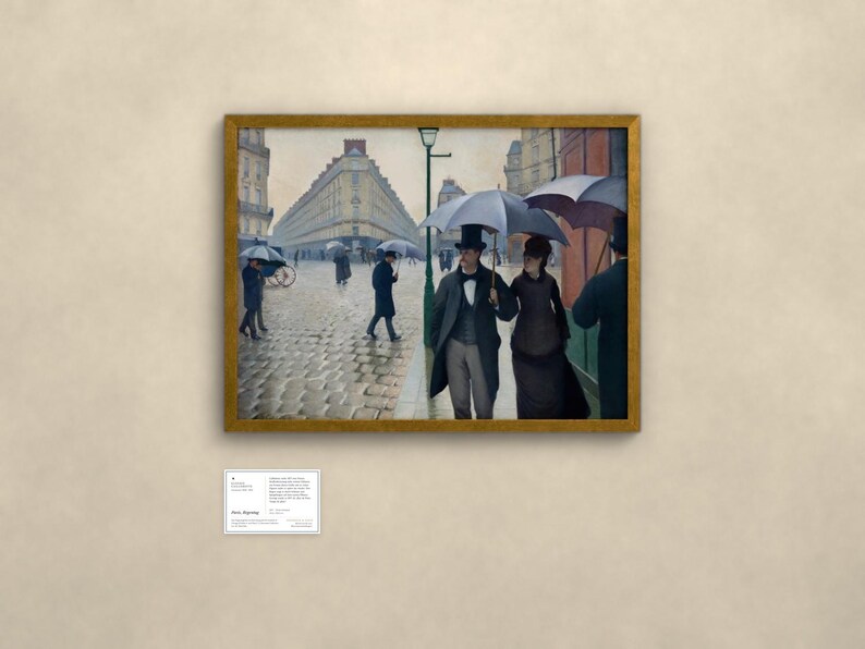 May include: A framed oil painting depicting a rainy Paris street scene with cobblestones. Several figures walk under dark umbrellas, including a couple in the foreground wearing formal attire and top hats. A tall green lamppost stands nearby.