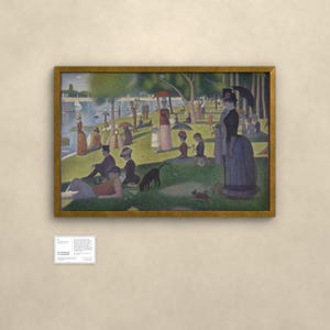 May include: A framed print of Georges Seurat's A Sunday Afternoon on the Island of La Grande Jatte, featuring a park scene with people, a dog, and a river. A small white informational plaque is mounted on the wall below the framed artwork.