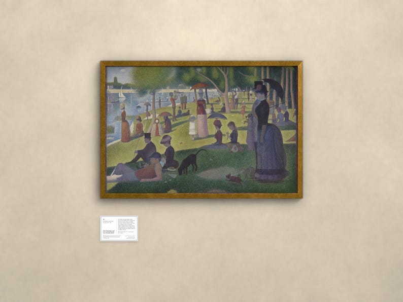 May include: A framed print of Georges Seurat's A Sunday Afternoon on the Island of La Grande Jatte, featuring a park scene with people, a dog, and a river. A small white informational plaque is mounted on the wall below the framed artwork.