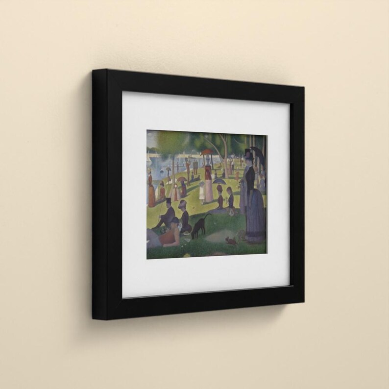 May include: A framed print featuring a reproduction of Georges Seurat's A Sunday Afternoon on the Island of La Grande Jatte. The artwork is encased in a black frame with a white mat, displaying figures in a park setting by the water.