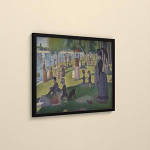 May include: A framed print of a pointillist painting depicting a park scene by a river. Numerous figures in period clothing are scattered across a green lawn, some holding umbrellas or parasols, with sailboats visible on the water in the distance.