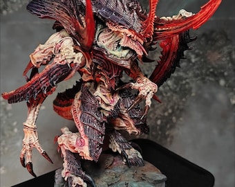 May include: A detailed miniature creature figure featuring a dark purple and black chitinous exoskeleton with bright red blade-like appendages, exposed pale bone-like muscle structures, and sharp claws, standing on a textured rocky base.