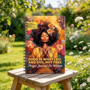 May include: A spiral-bound journal featuring a colorful illustration of a person with dark curly hair adorned with flowers, hands pressed together in prayer, and the text: GOOD IS WHAT I DO AND EVIL NOT FREE Prayer Journal For Women.