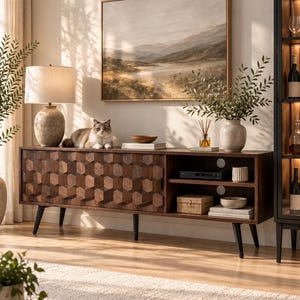 May include: A dark brown wooden media console featuring a geometric hexagonal pattern on its cabinet doors, supported by four black tapered legs. The unit includes open shelving on the right side, housing a small box, a bowl, and books.