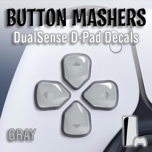 May include: Gray D-Pad Decals for the DualSense controller. The decals are shaped like the directional buttons on the controller. The text "BUTTON MASHERS" and "DualSense D-Pad Decals" is at the top of the image. The word "GRAY" is at the bottom left of the image.