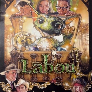 May include: A movie poster for the film "Labou" featuring a green, dragon-like creature with large eyes and a toothy grin. The creature is peeking out of a treasure chest filled with gold coins. The poster also features several human characters, including a young girl, a young boy, and an older man with a cowboy hat.