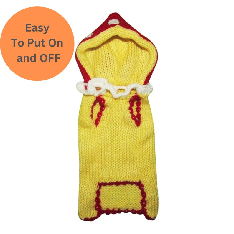 May include: Yellow knitted dog sweater with a red and white hooded top. The sweater has a red trim around the neck, sleeves, and bottom. The hood has white polka dots.