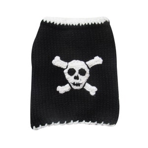 May include: Black crocheted dog sweater with a white skull and crossbones design.