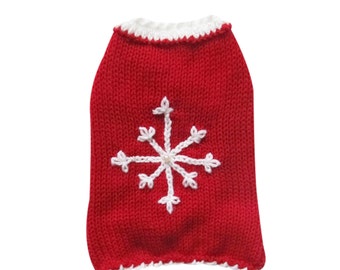 May include: Red knitted dog sweater with a white snowflake design and a pearl accent.