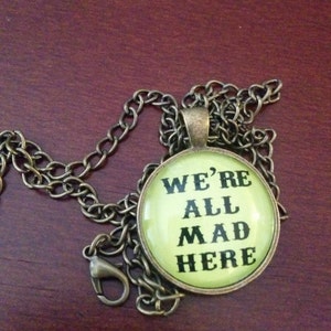 We&#039;re All Mad Here pendant quote Alice in Wonderland jewelry