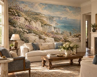 May include: A large wall mural depicting a coastal landscape with white cliffs, blue ocean, and wildflowers. The room features a beige sofa with blue and patterned pillows, a wooden coffee table, and a blue armchair on a patterned rug.