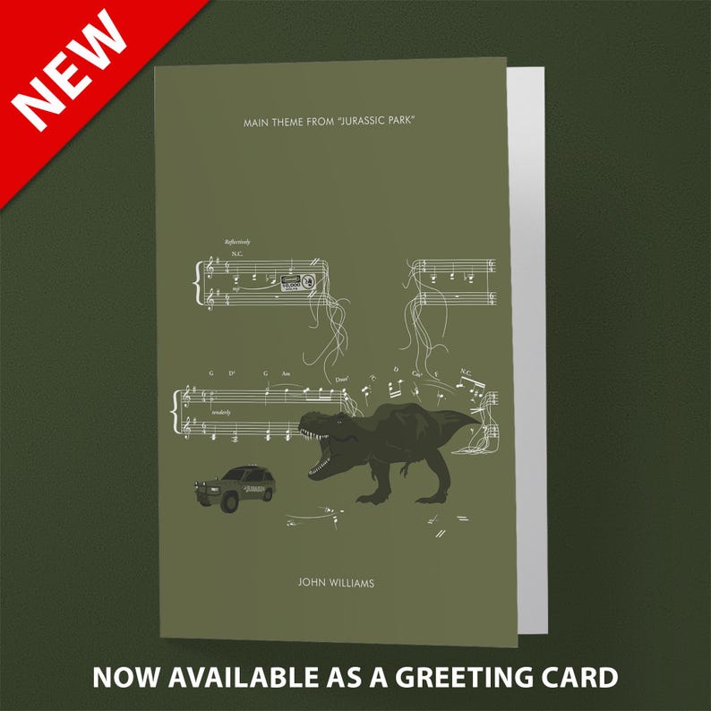 May include: A green greeting card with a white illustration of a Tyrannosaurus Rex dinosaur roaring over a musical score. The text "MAIN THEME FROM "JURASSIC PARK" and "JOHN WILLIAMS" are printed on the card.