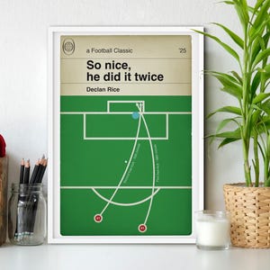 May include: A white framed print with a green soccer field and white lines. The print has the text "a Football Classic" and "So nice, he did it twice" with the name "Declan Rice" below. The print has a number "25" in the top right corner.