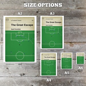 May include: A collection of football-themed art prints in various sizes, including A2, A3, A4, A5, and A6. Each print features a green field diagram with player positions and the title "The Great Escape" by Geoff Horsfield. The prints are displayed on a wooden surface.