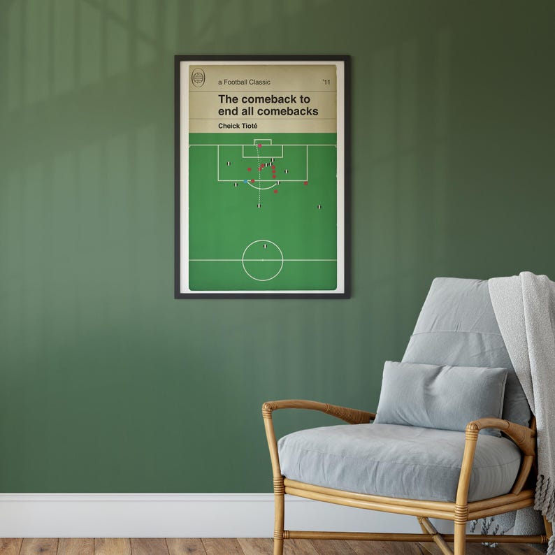 May include: A framed poster with a green soccer field and a black and white illustration of a soccer game. The poster has the text "a Football Classic" and "The comeback to end all comebacks" with the name "Cheick Tiot&eacute;" below.